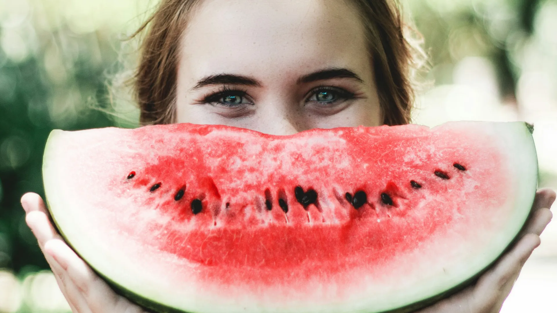 a person holding a watermelon