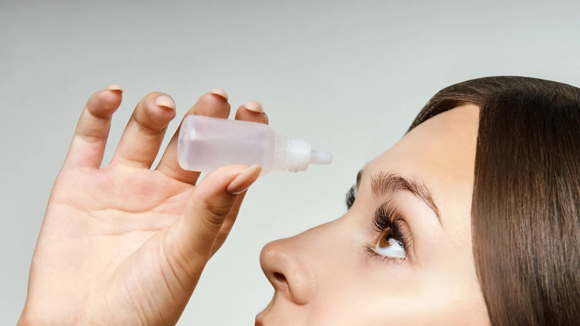 a woman's face with a bottle of hair