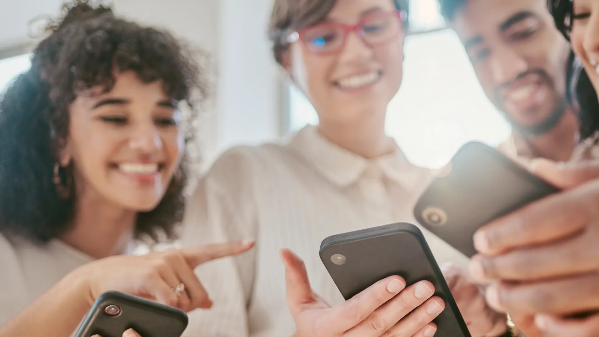 a group of people looking at their phones