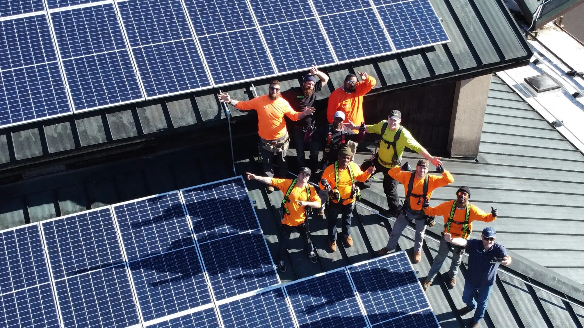 solar, battery & heat pump installers on a greenbrae roof with solar panels