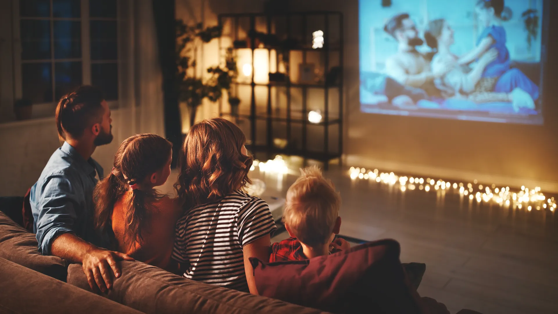 a group of people sitting in front of a television