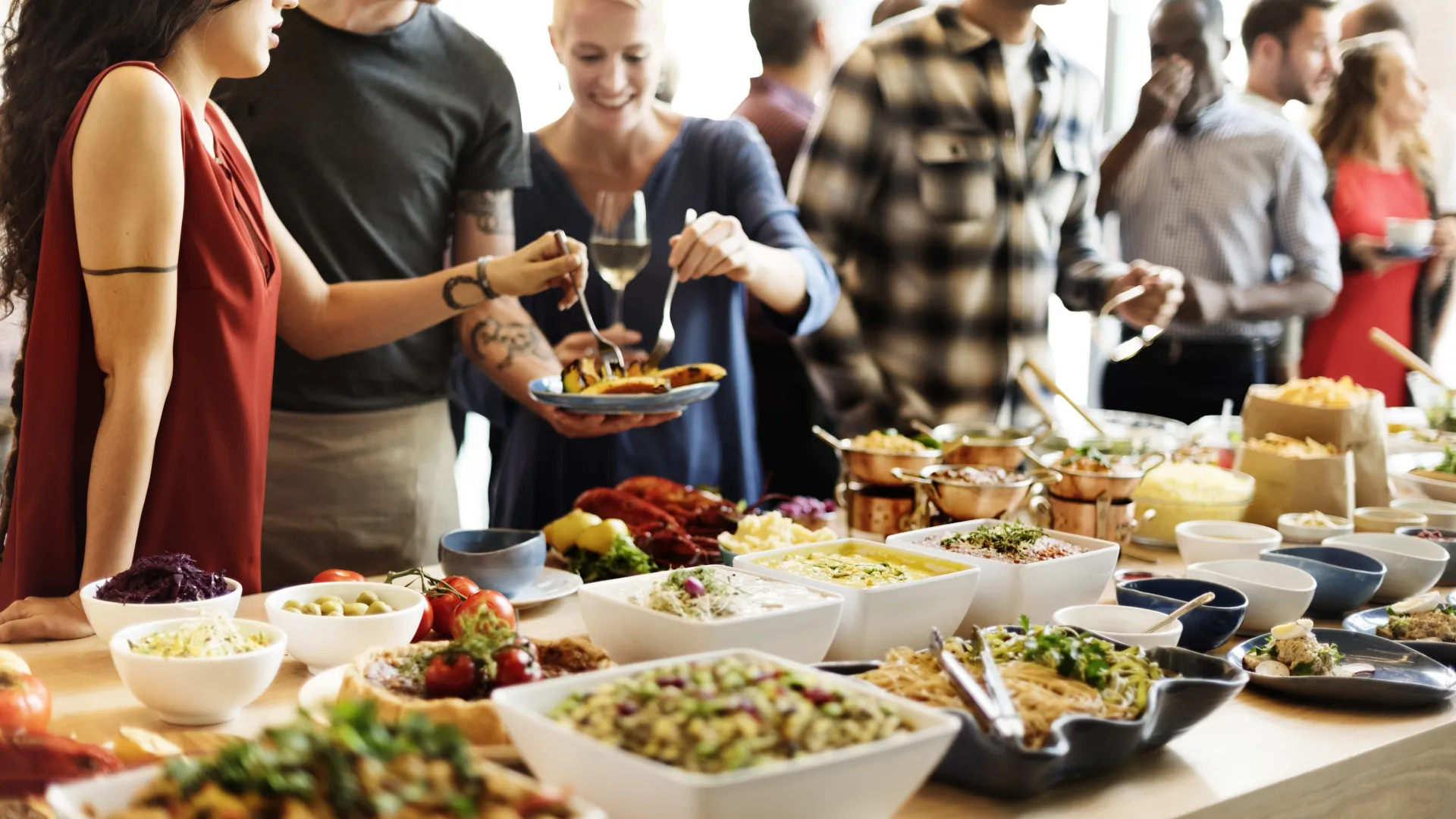 a group of people sitting at a table with a plate of food