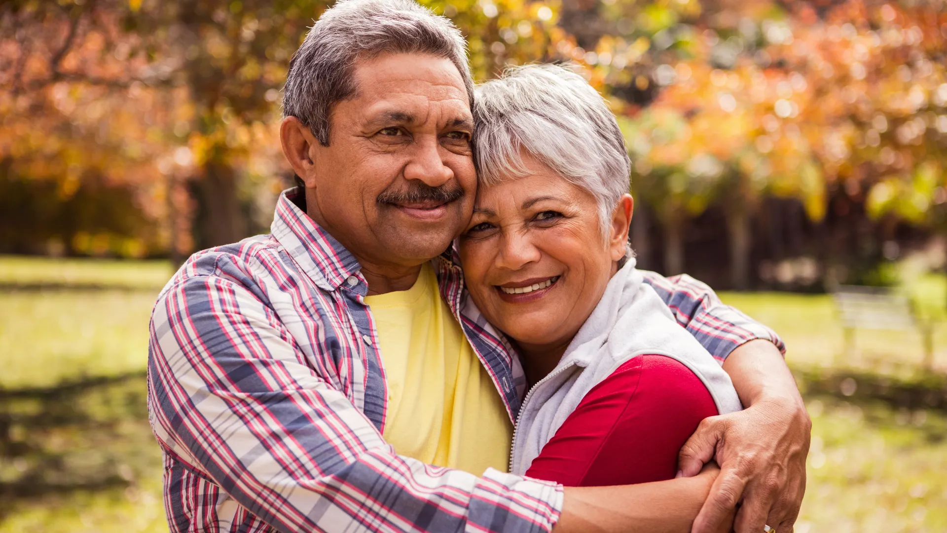 a man and a woman smiling for the camera