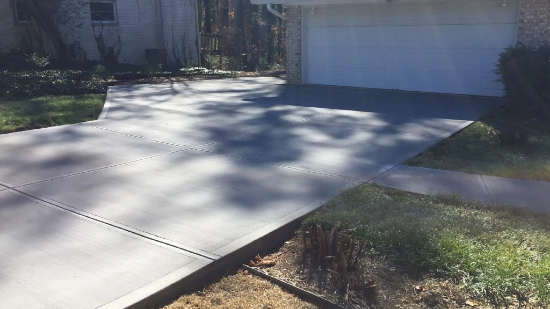 a driveway with a puddle of water