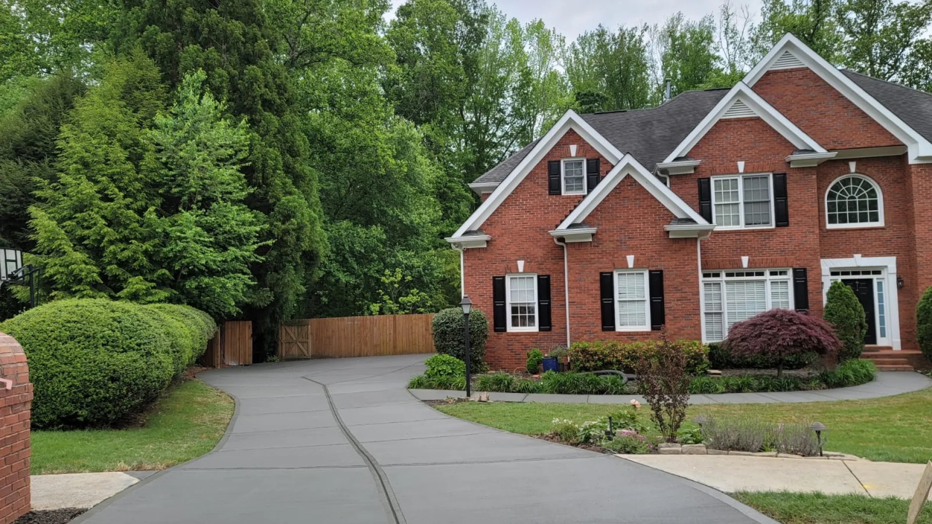 a house with a driveway and trees