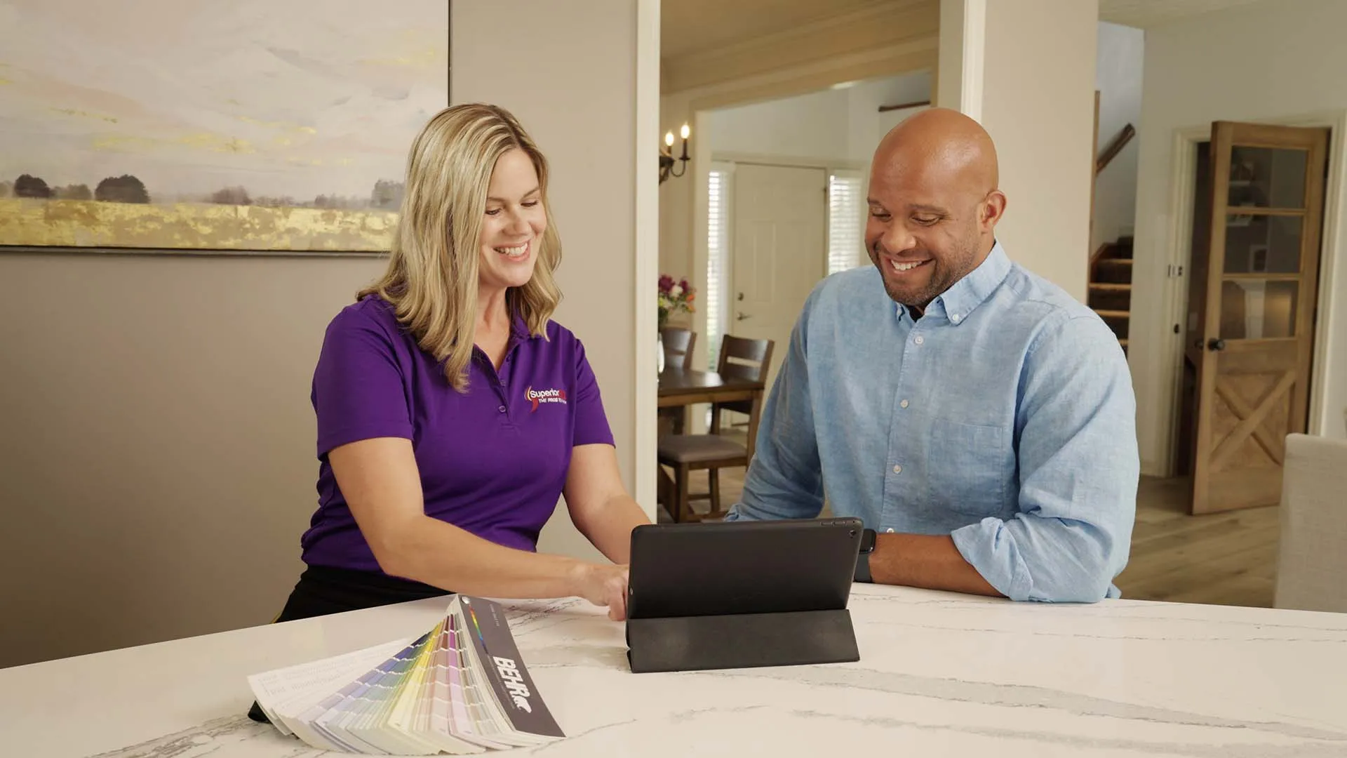 a man and a woman looking at a laptop