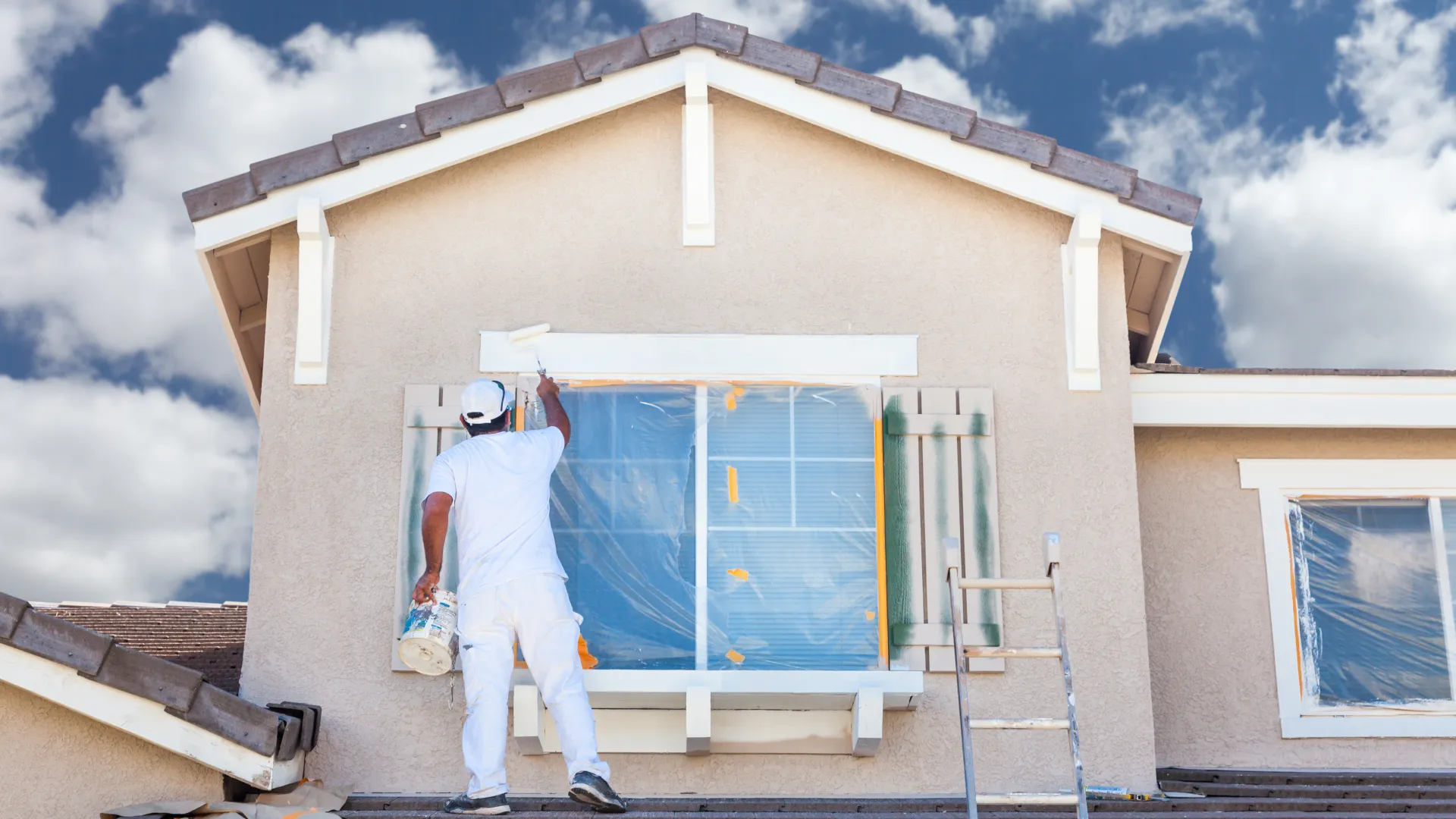 a person painting a house