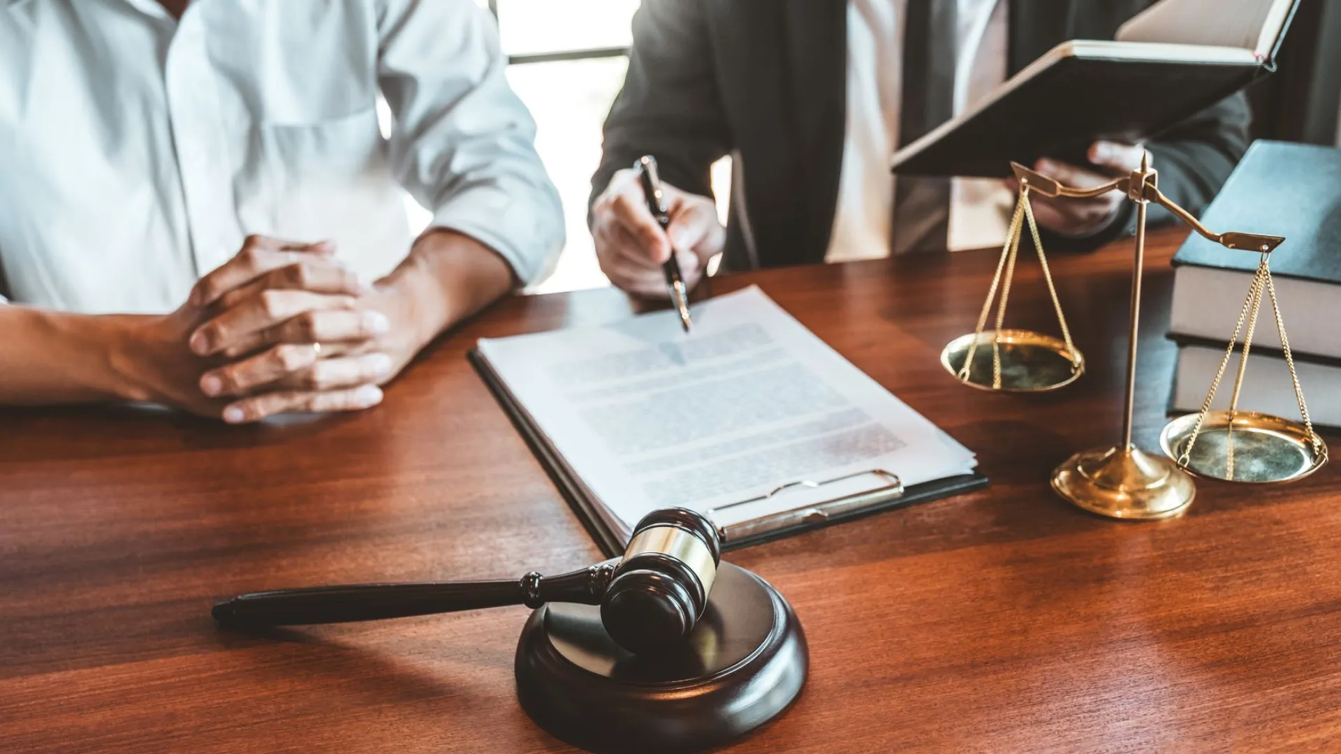 two people sitting by each other at a desk