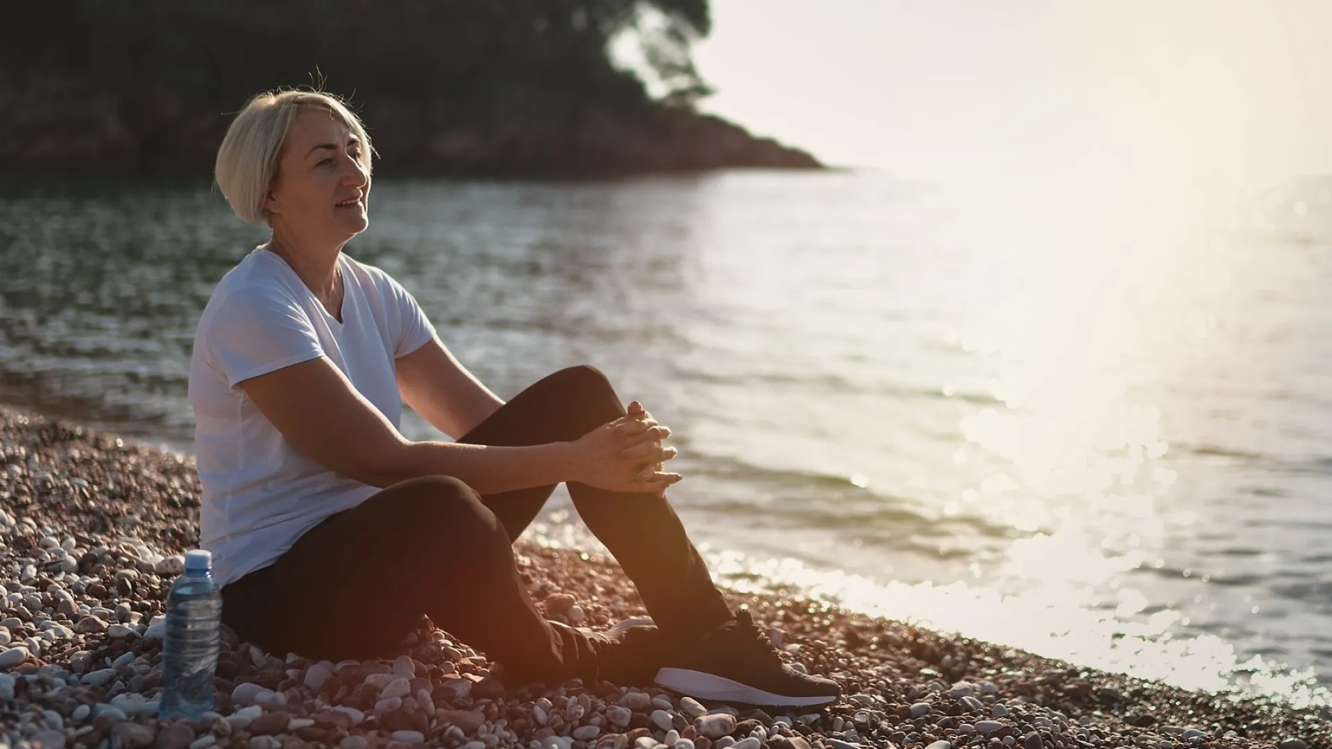 a woman sitting on the beach