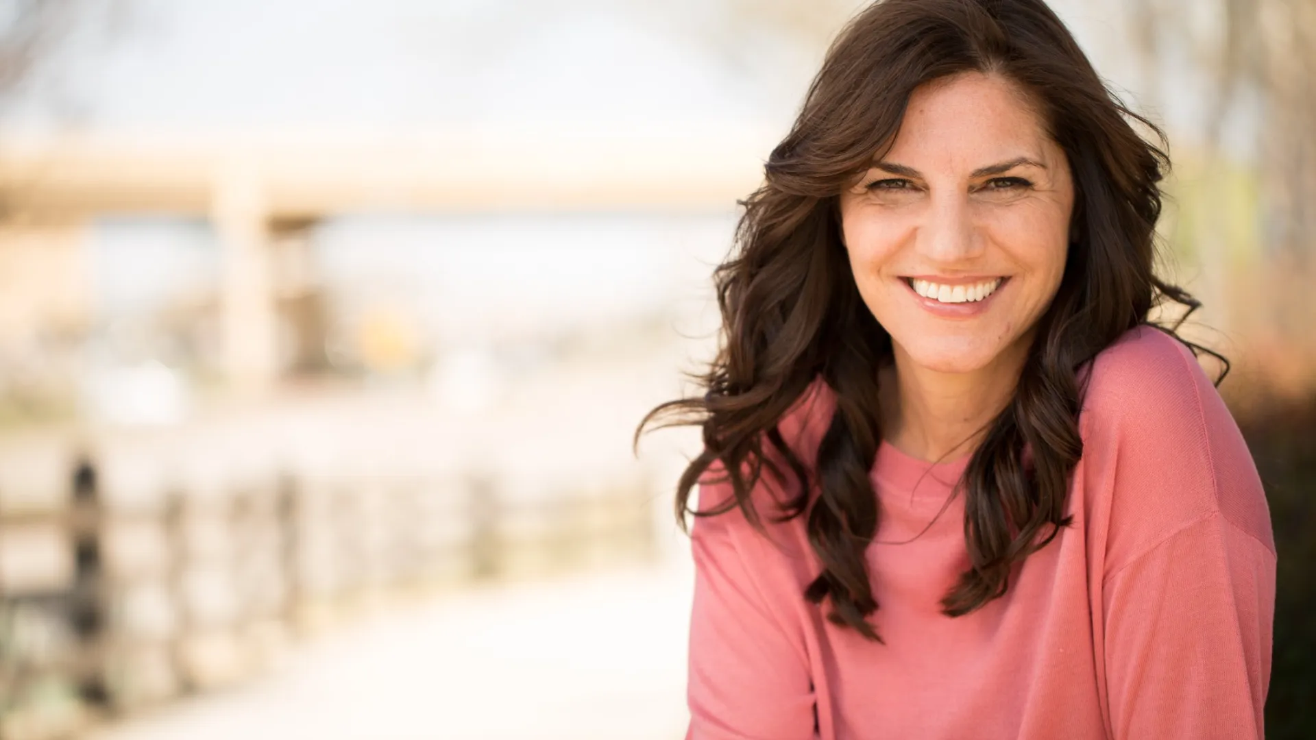 a woman smiling outside