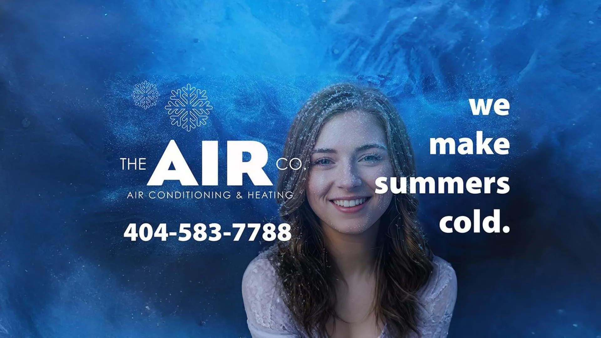 Smiling woman with cold breath effect on blue background promoting The Air Co heating and air conditioning service.