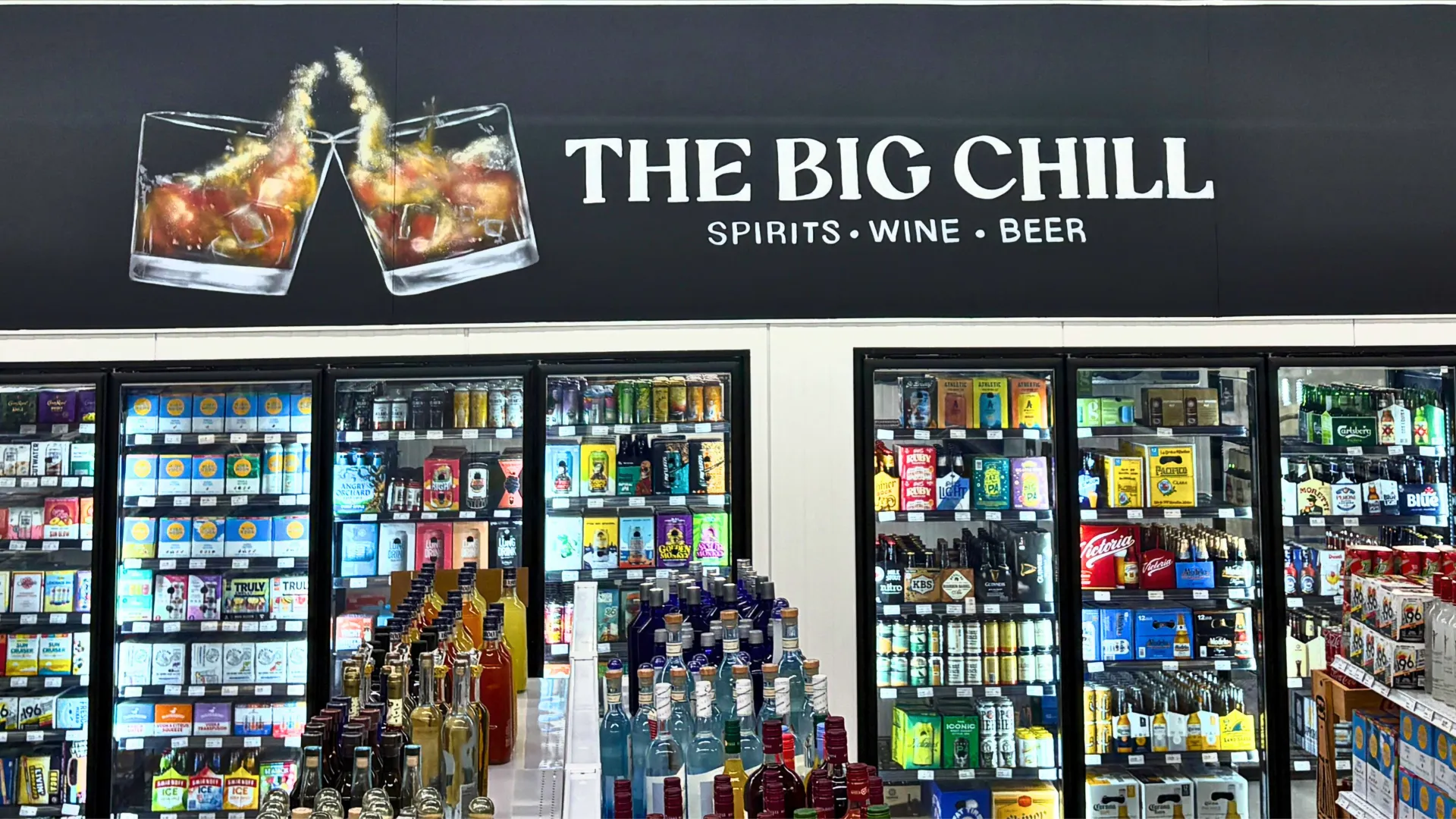 Interior of The Big Chill store displaying liquor bottles and coolers filled with spirits, wine, and beer.