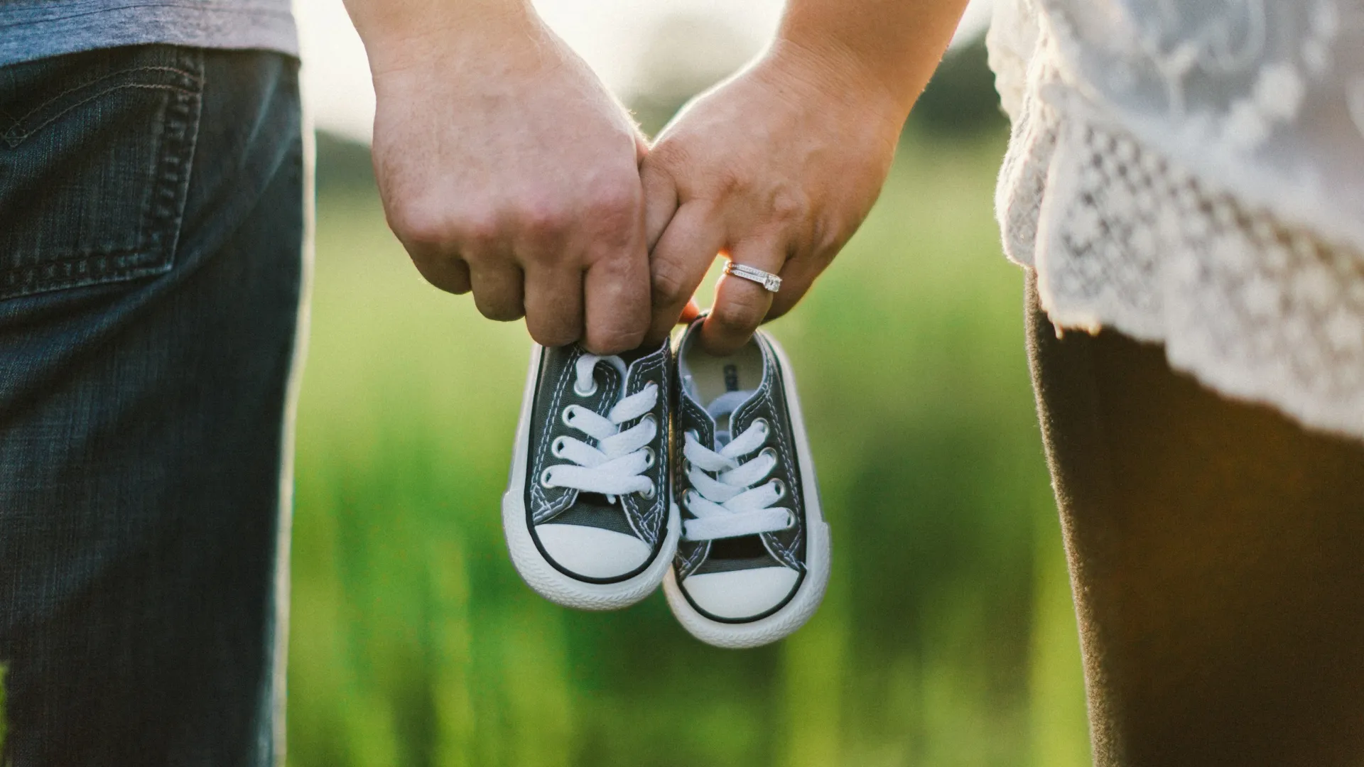 a pair of hands holding a shoe