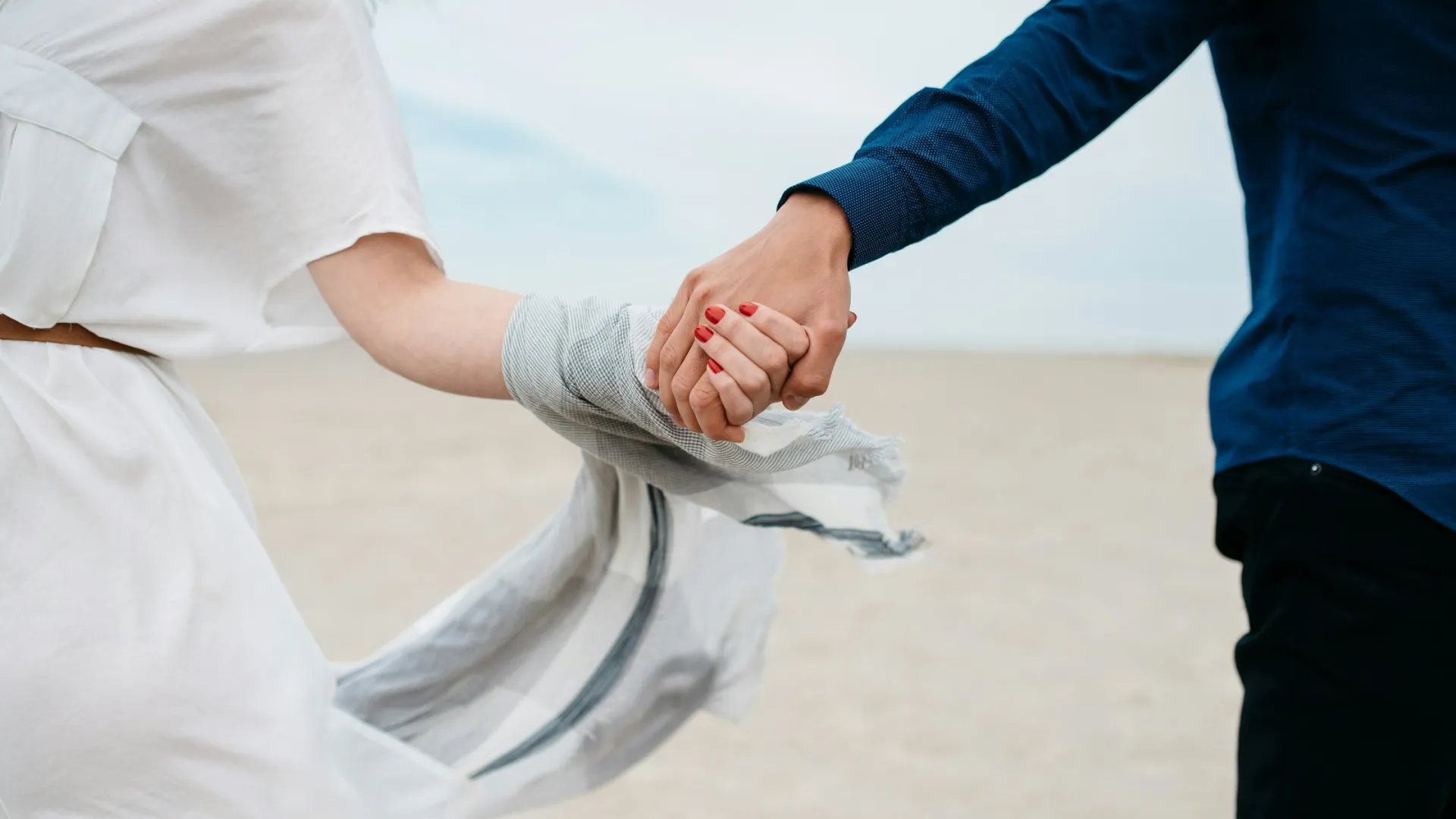 a man and woman holding hands