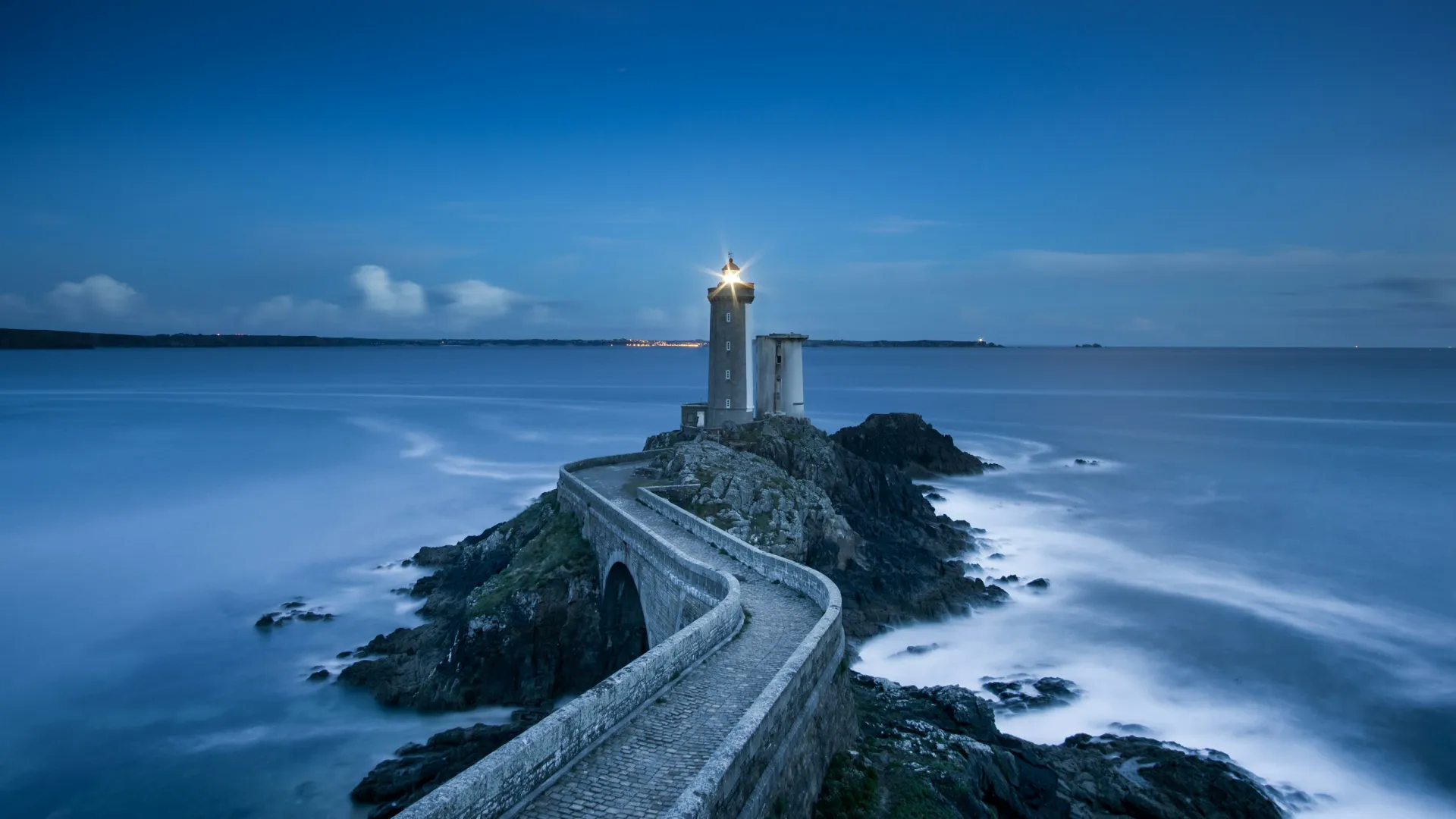 a light house on a rocky cliff above the ocean