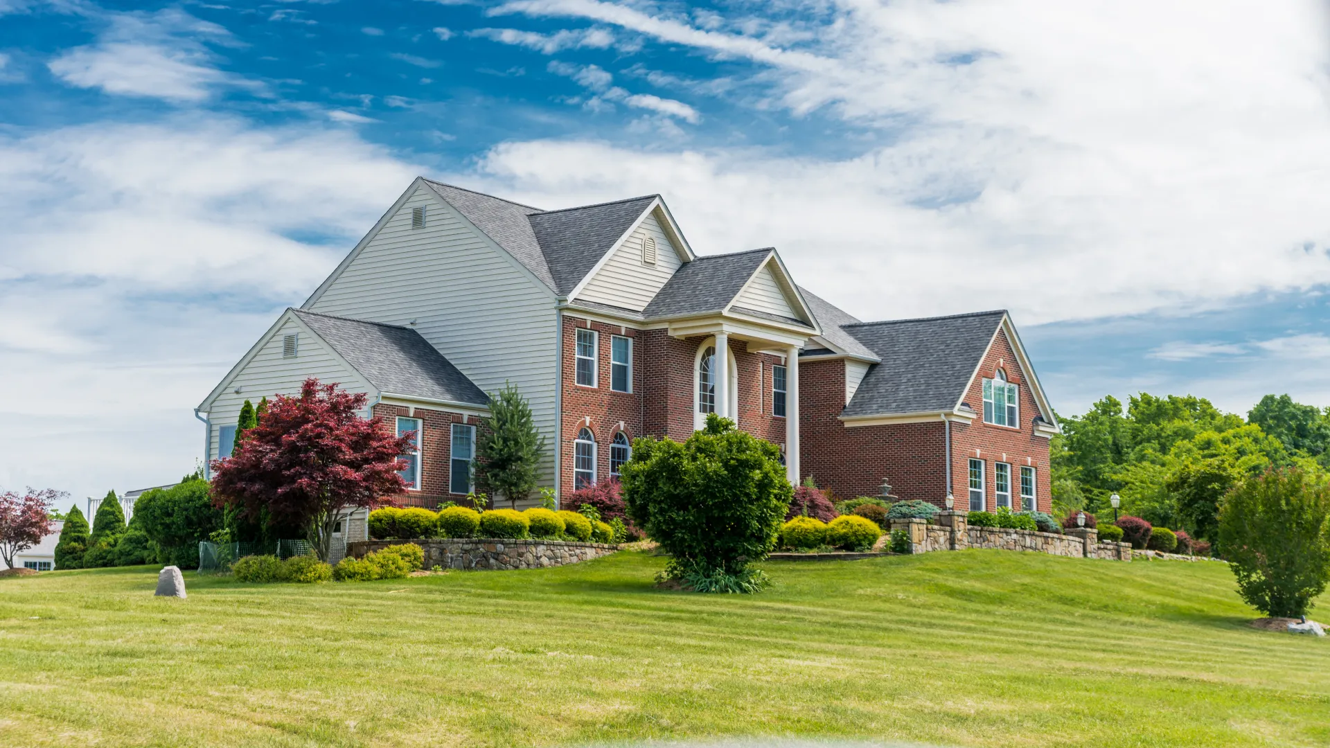 a large house with a lawn in front of it