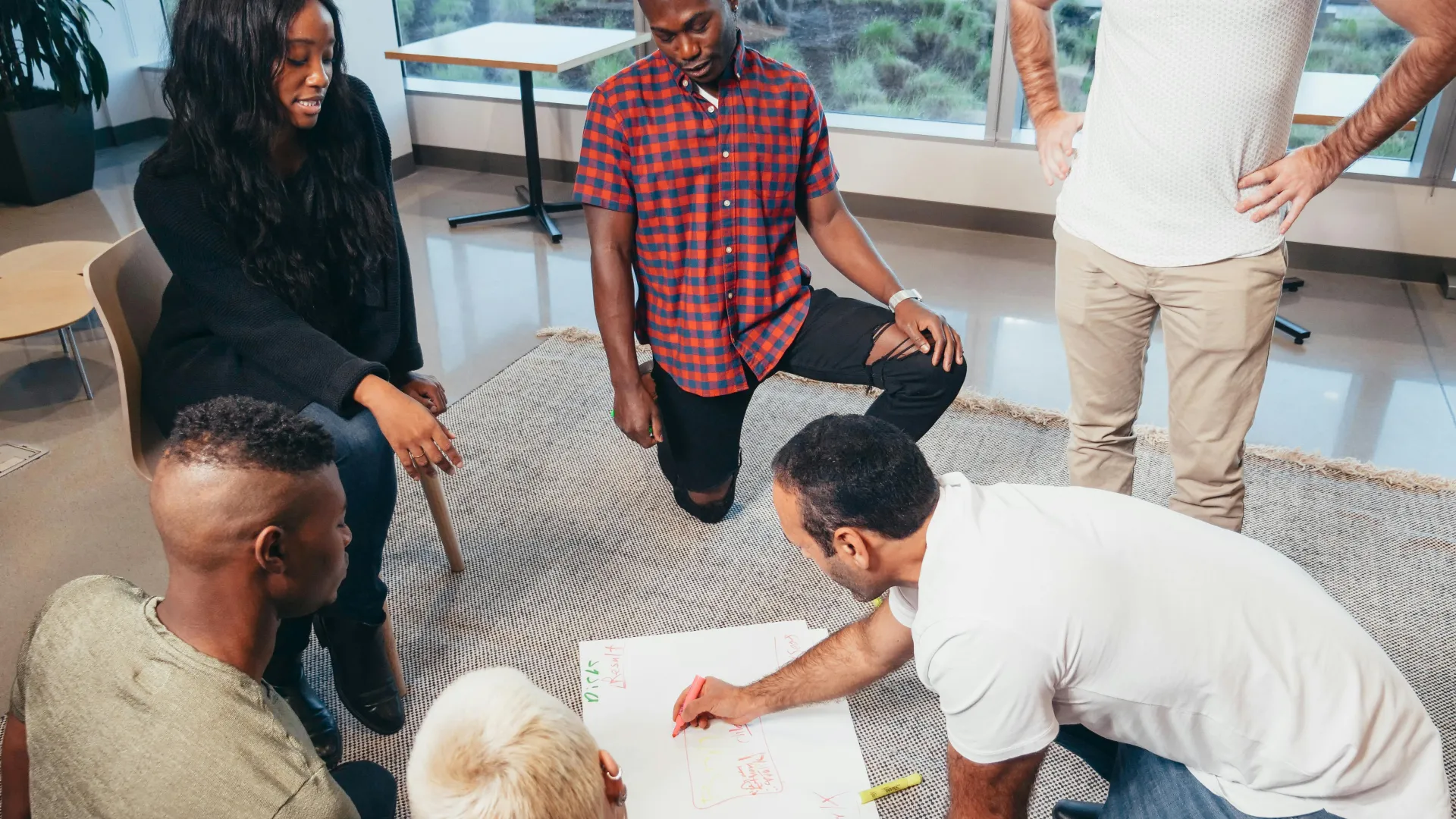 a group of people looking at a paper