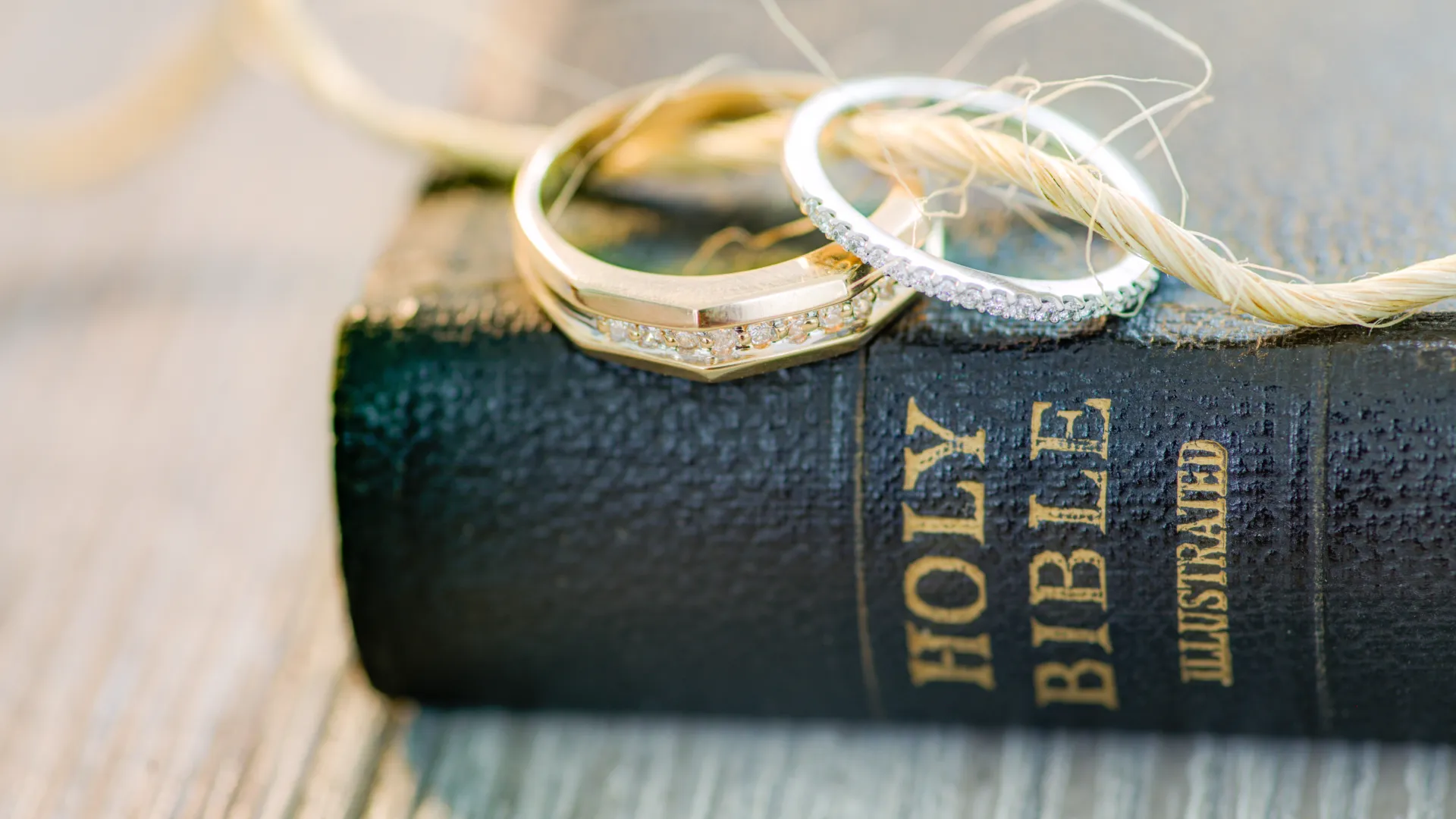 a pair of gold rings on a black wallet