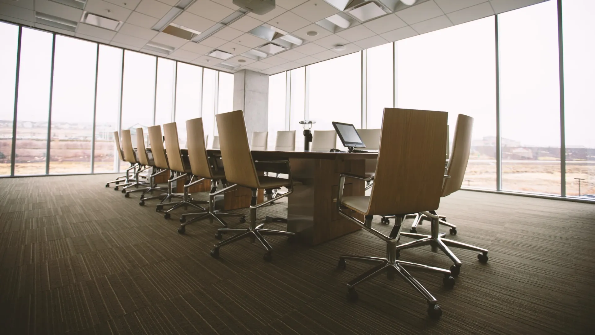a room with a desk and chairs