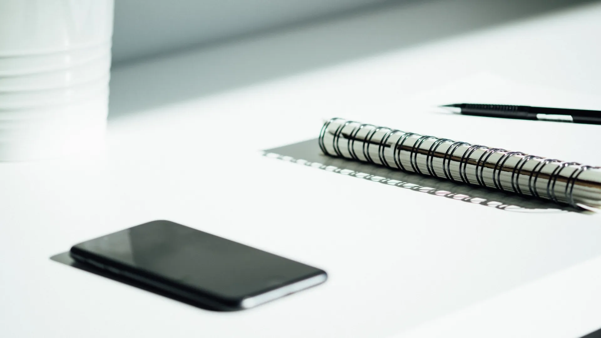 a pen and a cell phone on a table