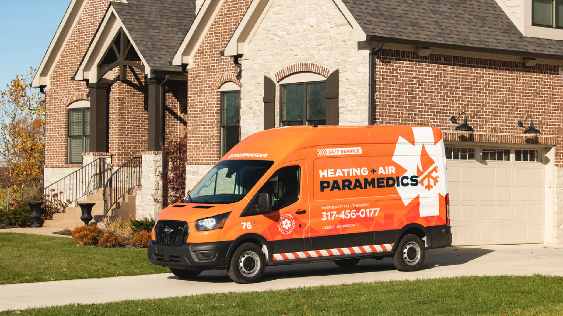 A vibrant service van for Heating & Air Paramedics parked in front of a modern, brick house.