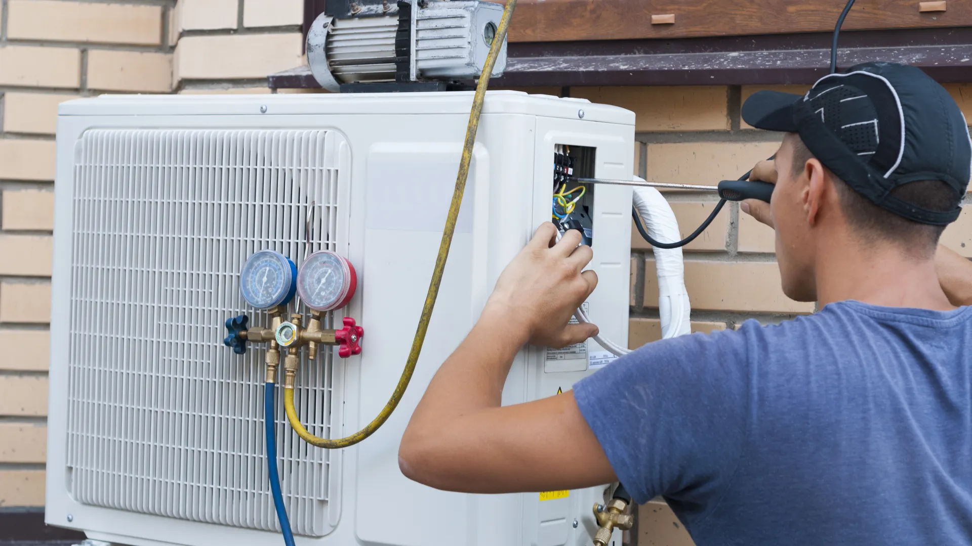 Worker repairing air conditioner