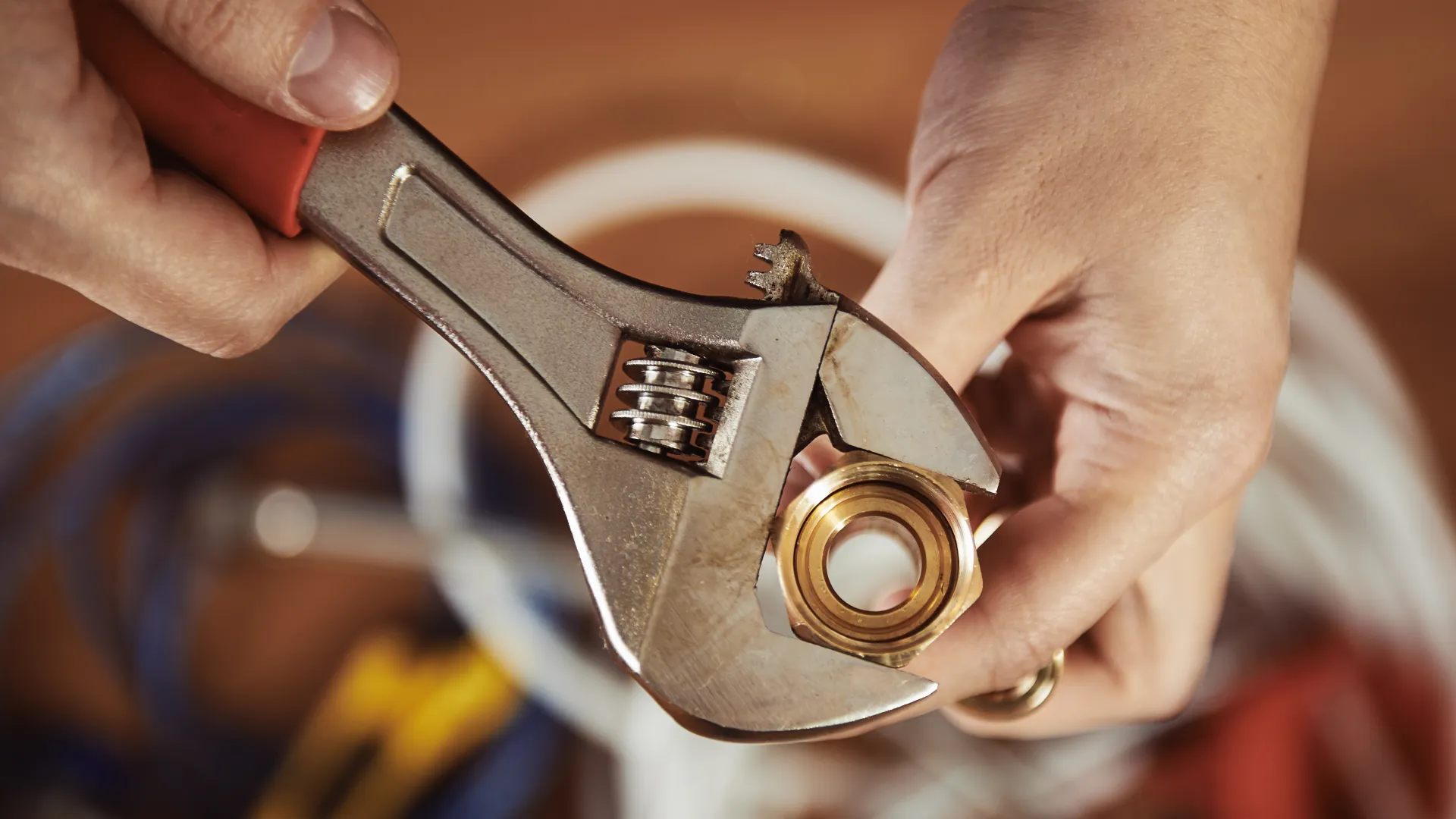 a hand holding a wrench