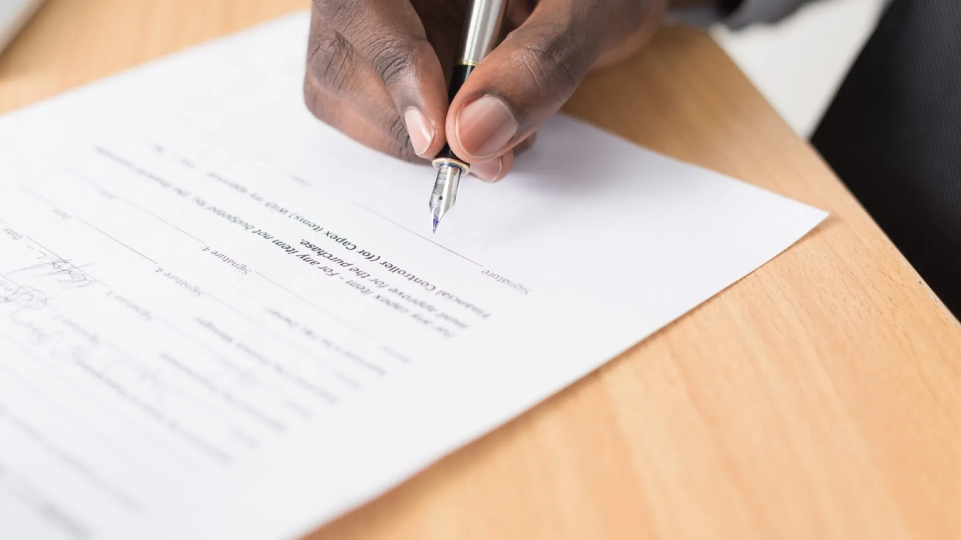 a man signing paper