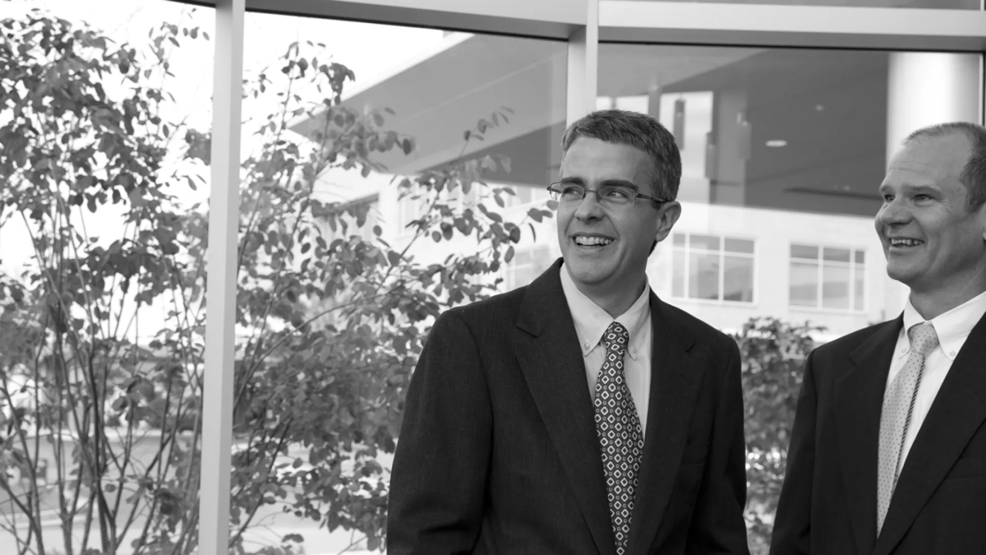 a man wearing a suit and tie posing for a photo