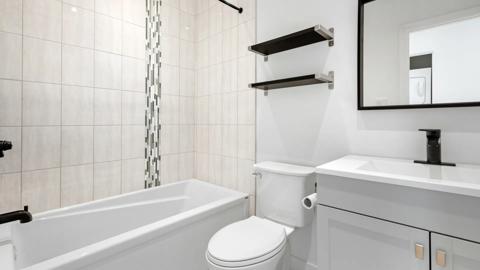 Man repairing a toilet tank using an adjustable wrench in a clean bathroom with white tiles.