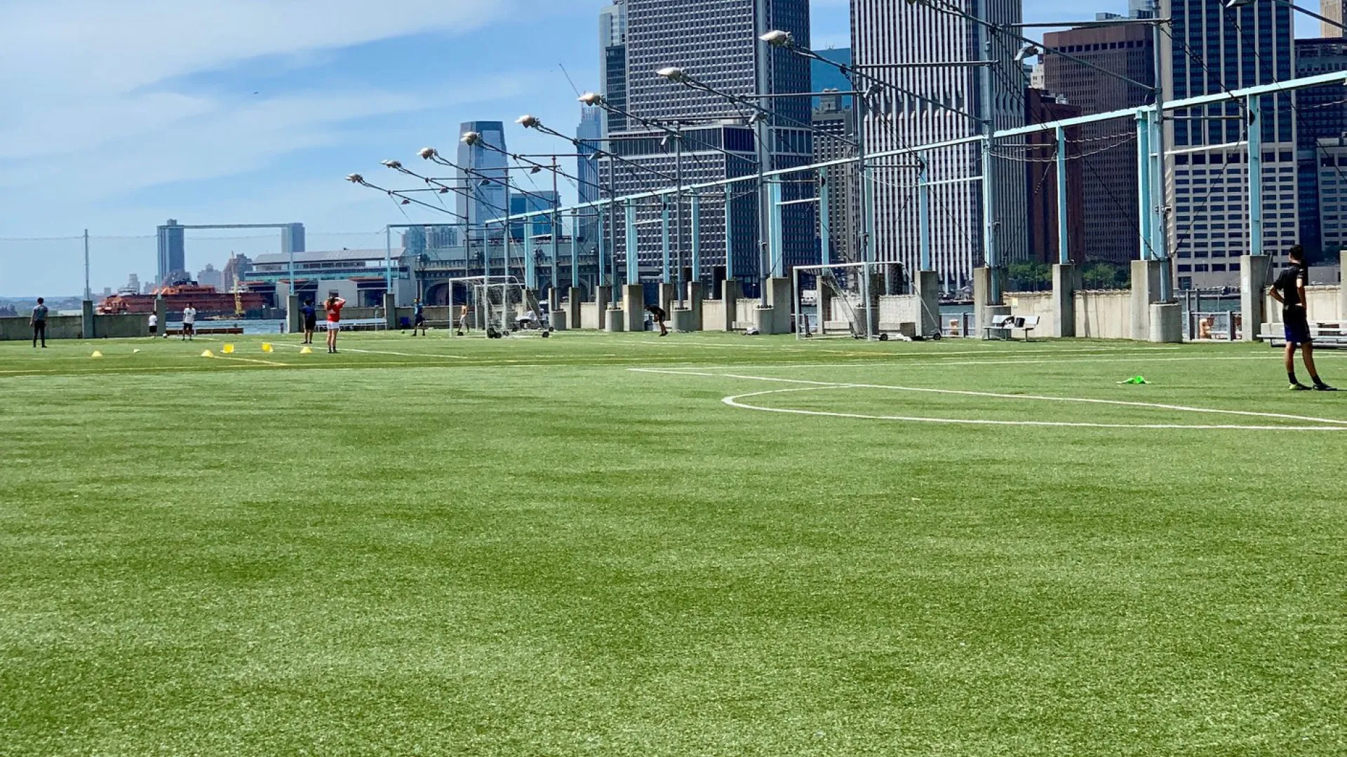 a grassy field with buildings in the background