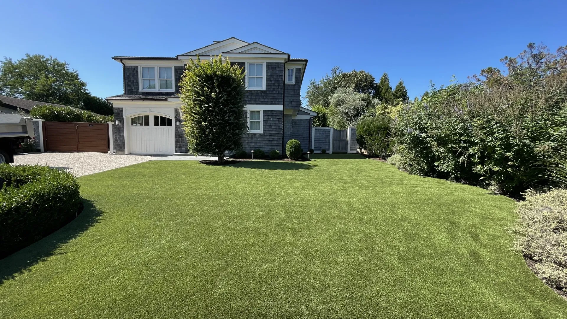 a house with a large artificial lawn