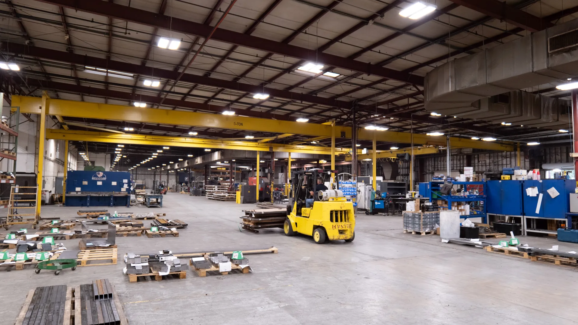 a warehouse with a yellow truck