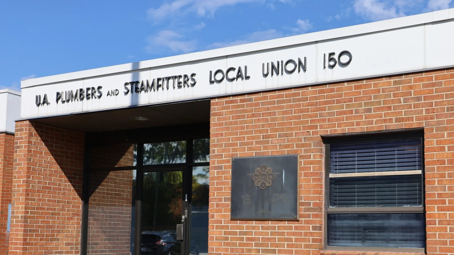 Exterior view of UA Plumbers and Steamfitters Local Union 150 building with modern architecture.