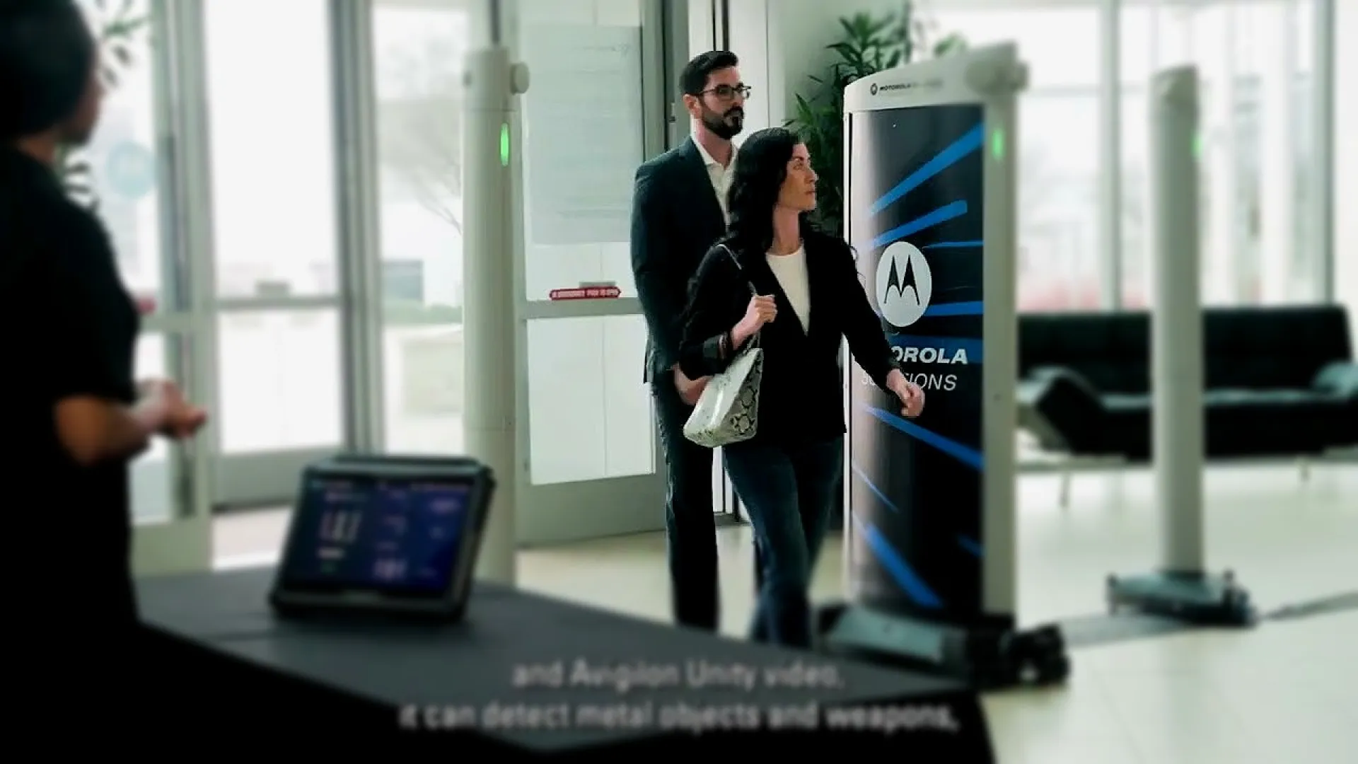 a group of people standing around a table with a laptop