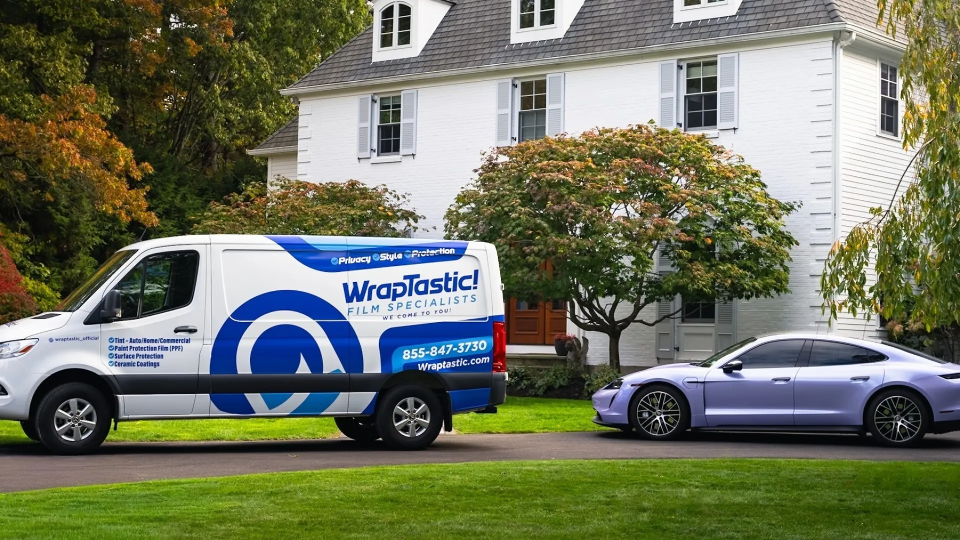 WrapTastic van parked on driveway next to luxury car in front of white house with autumn trees