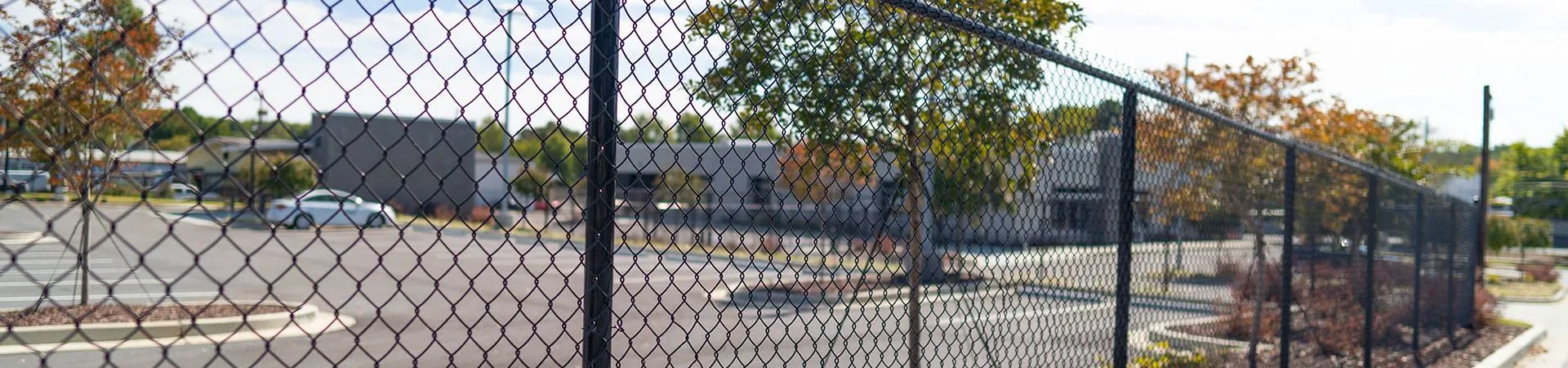 a fenced off area with a chain link fence and a street