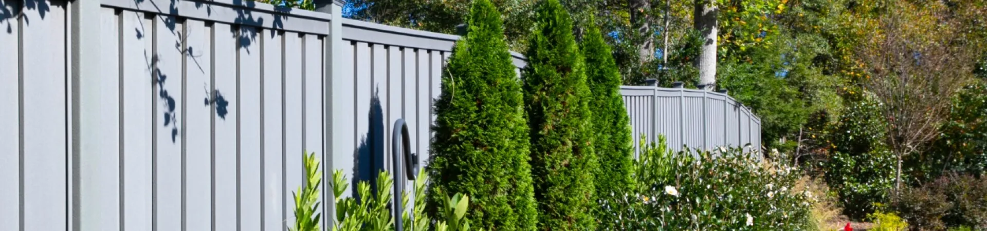 a garden with a fence and trees