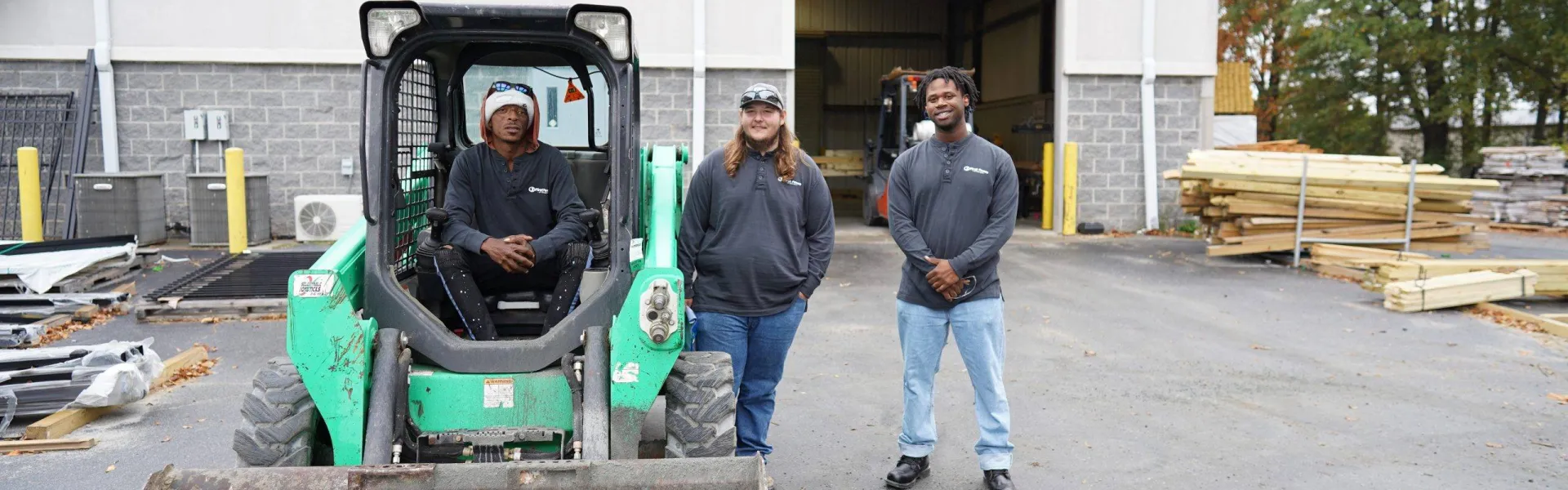 a man and a woman standing next to a tractor