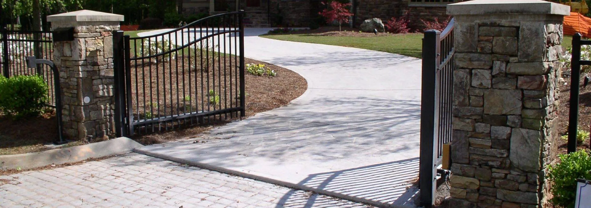 a gated driveway leading to a house