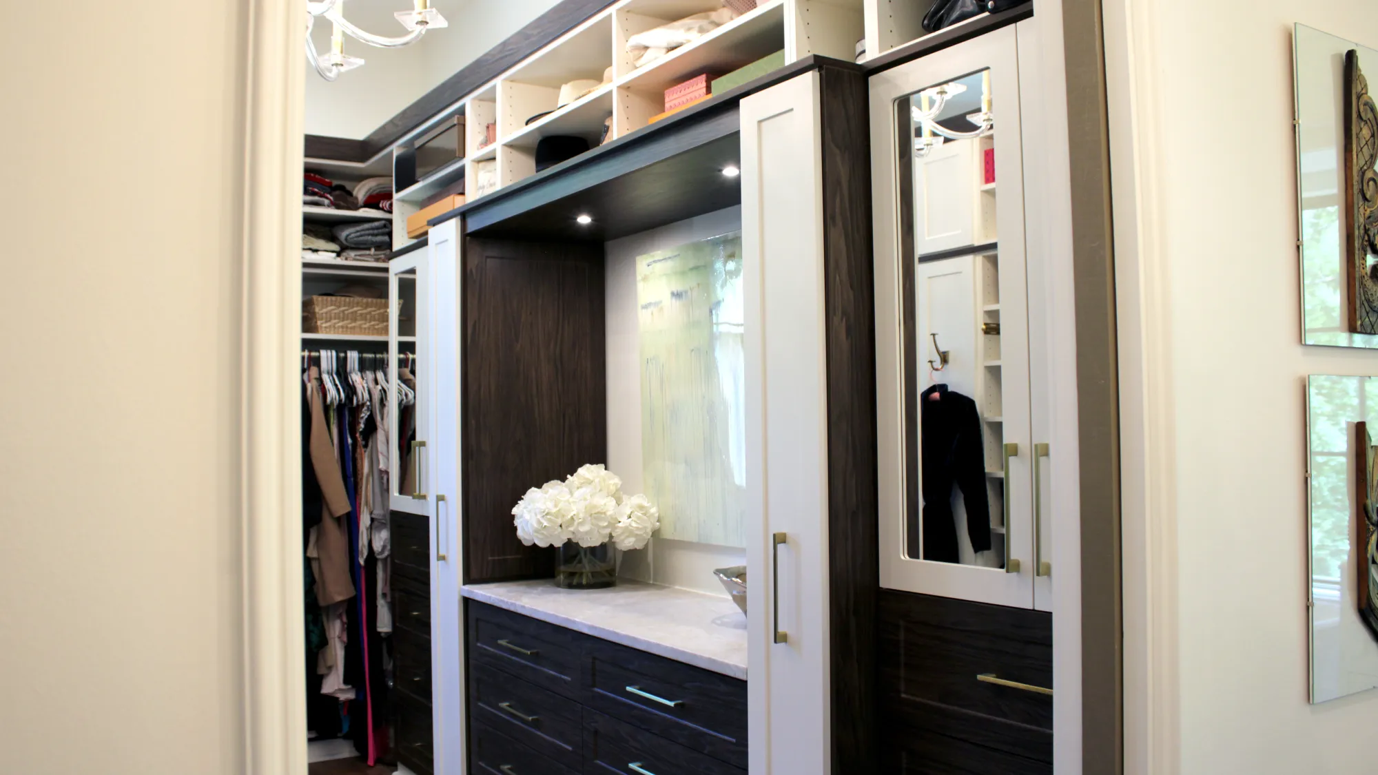 a closet with a mirror and a flower in it