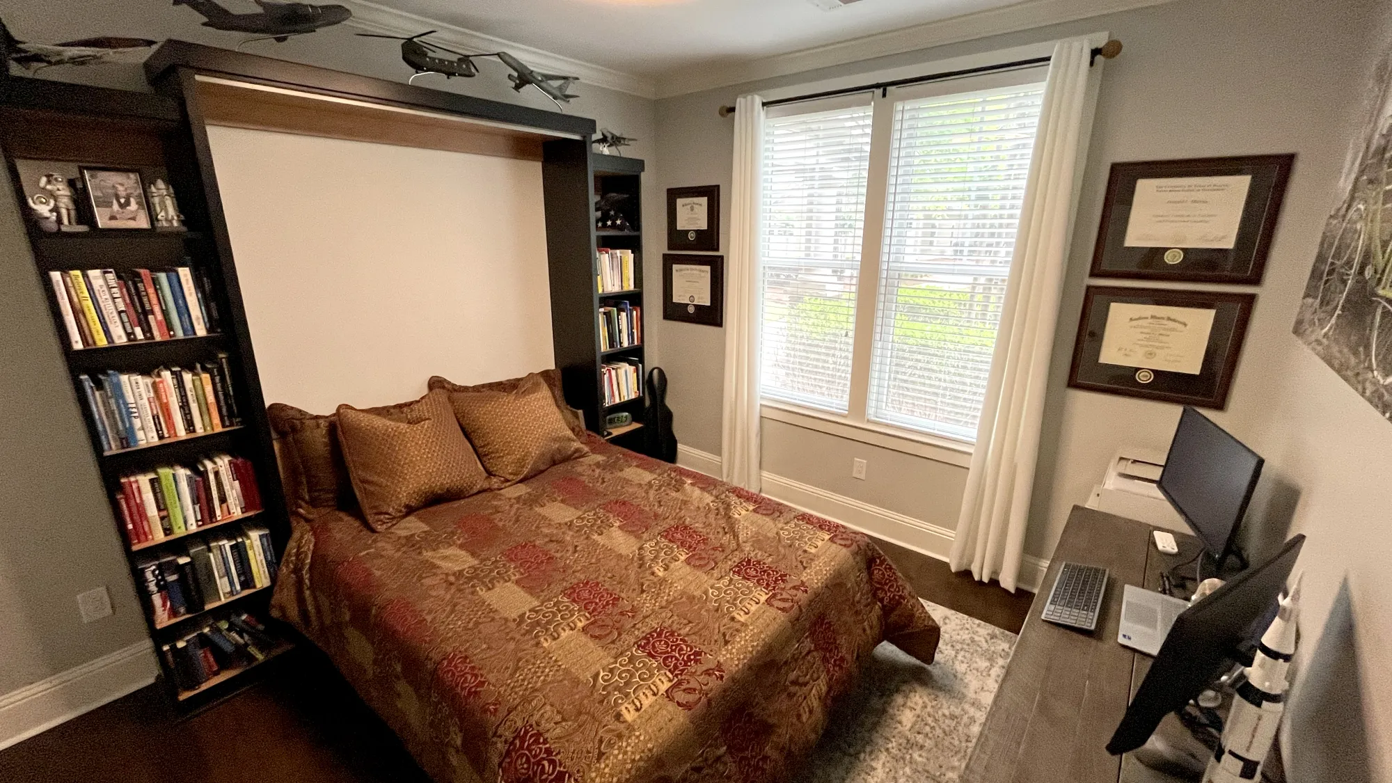 a bedroom with a bed and bookshelves