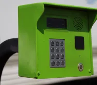 a green telephone on a table