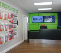 a room with a black counter and a green board with white text