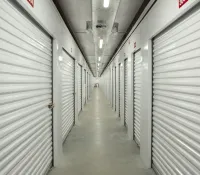 a long hallway with white lockers