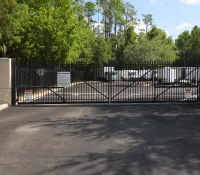 a black gate with a sign on it