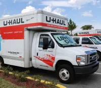 a white truck with a red and blue sign on it