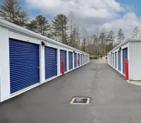 a row of white and blue sheds