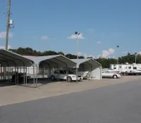 a group of white vans parked outside a building