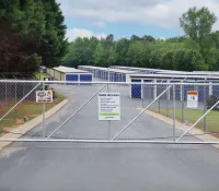 a road with a fence and a building in the background